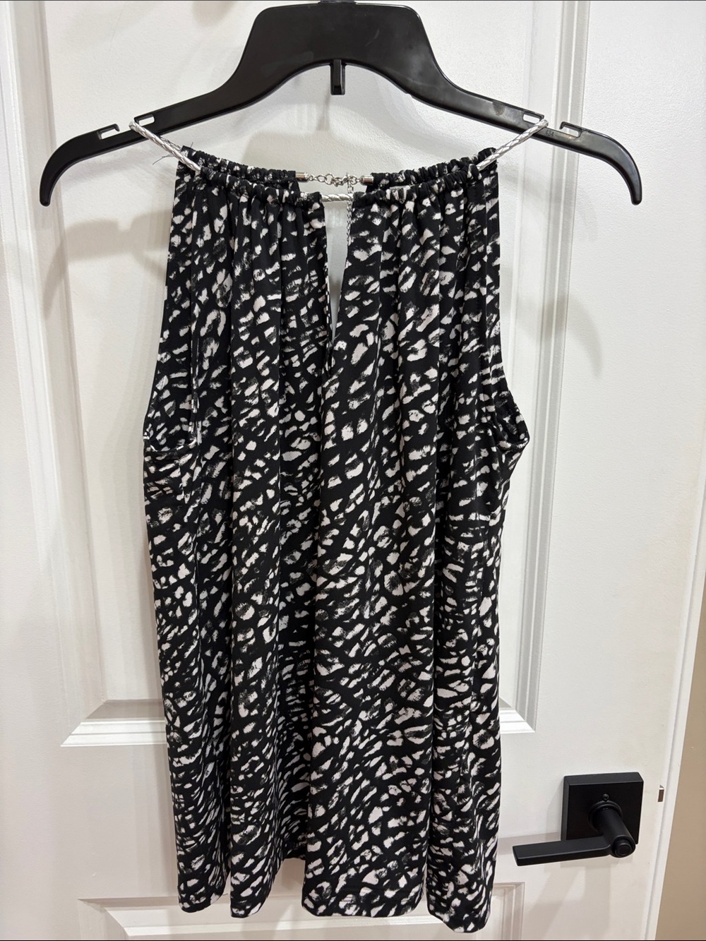 Michael Kors Black and White Printed sleeveless blouse.